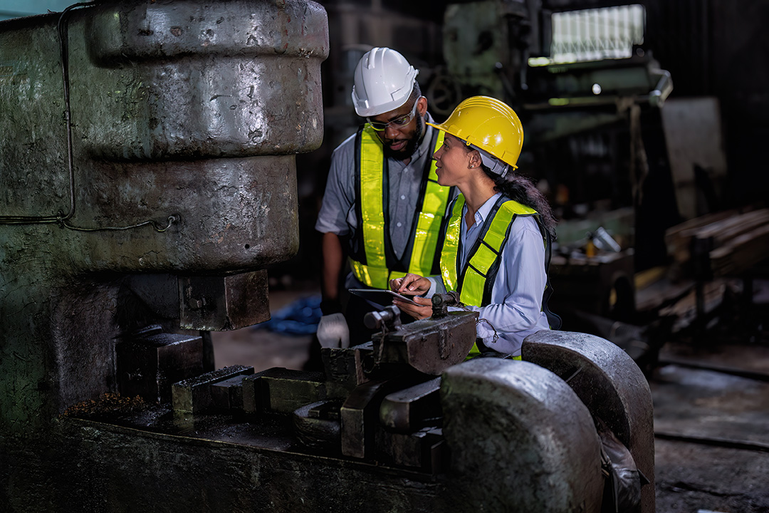 An engineer inspecting industrial machinery